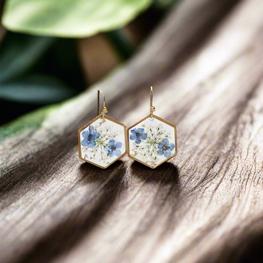 Hexagonal earrings with floral design on a branch, showing measurements.
